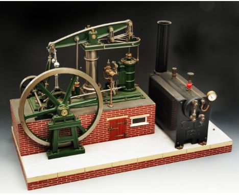 A Stuart Beam Engine powered by a Stuart stationary boiler raised on a mock brick work plinth, 23cm diameter flywheel, 25cm b