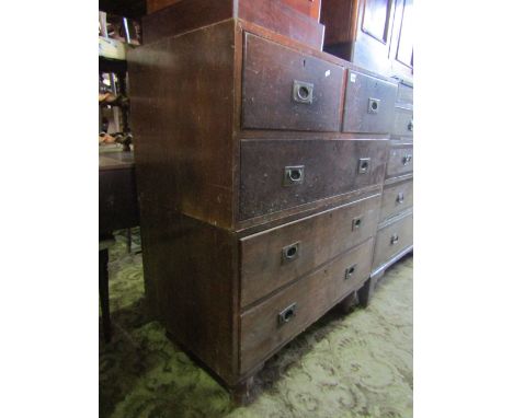 A vintage military style two sectional chest of three long and two short drawers with brass flush fitting handles and turned 