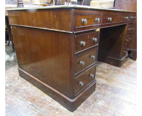 A Georgian style mahogany partners writing desk fitted with an arrangement of twelve drawers and two cupboards, with inset pa