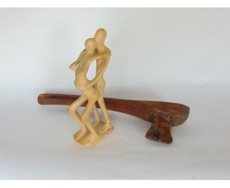 Primitive flint axe, together with a soapstone figure of two lovers embracing and a horn handled specimen cane(3)