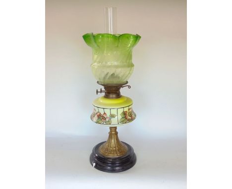Late 19th century oil lamp with opaline glass reservoir painted with flowers upon a faceted brass column embossed with hearts