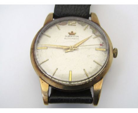 1950s Marvin Revue automatic 9ct gold gentleman's wrist watch, the champagne dial with gilt baton markers upon a vintage leat
