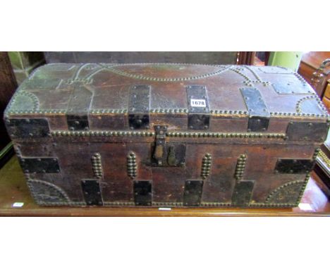 A Georgian travelling trunk, the dome lid and frame work with steel banded and brass buttoned detail, bearing the name plate 