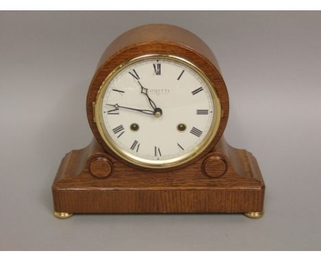 A Committi of London oak cased mantle clock, the drumhead movement striking on a bell, two train 12cm enamel dial, 22cm high