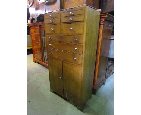 Vintage oak dental type freestanding cabinet, fitted with an arrangement of small drawers and two cupboard doors, containing 