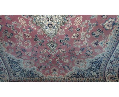 Indian wool carpet decorated with floral sprays upon a pink ground, 300 x 200 cm