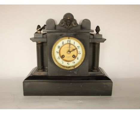 A 19th century black slate mantle clock, the architectural case enclosing an enamelled chapter ring and two train movement, 2