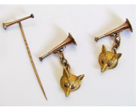 A pair of 9ct cufflinks in the form of hunting horn and fox mask with ruby eyes, together with a 9ct hunting horn stick pin, 