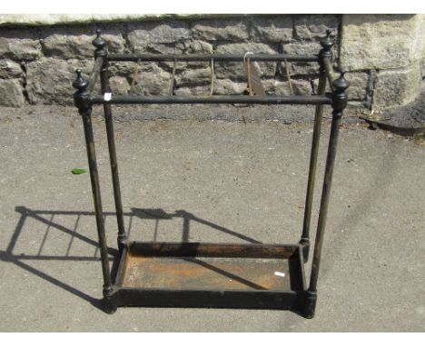 A Victorian brass six divisional umbrella/stick stand of rectangular form with simple tubular columns, urn finials and united