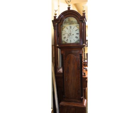 A Regency mahogany longcase clock with string banded inlay, the hood with arched outline and spiral column supports enclosing