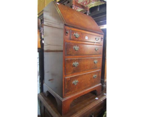 A reproduction Georgian style ladies writing bureau, the fall flap enclosing a fitted interior with small drawers and pigeon 