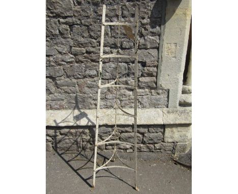 A vintage iron work floor standing six tier saucepan stand with painted finish