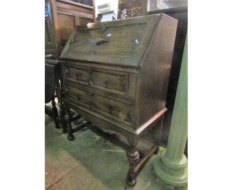 A 1920s Jacobean revival oak bureau with geometric mouldings together with an oak open bookcase, a reproduction mahogany thre