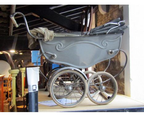 A vintage silver cross child's coach built pram, with sprung frame, spoke wheels and rubber tyres