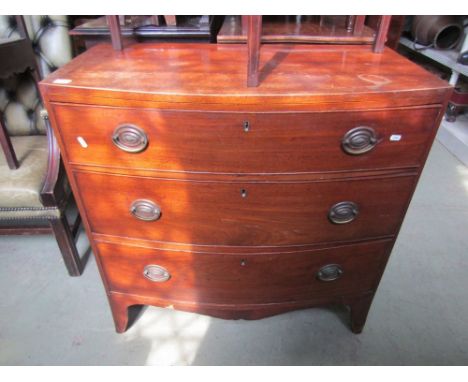 A Regency mahogany bow fronted chest, the caddy top over three long drawers with brass plate handles and swept supports, furt