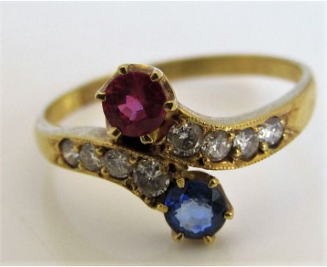 An 18ct sapphire, ruby and diamond crossover ring, size M/N, 2g