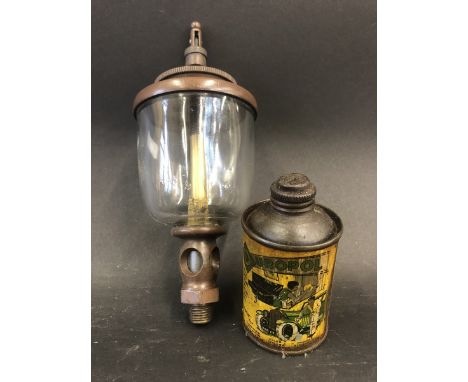 An unusual small cylindrical tin advertising Duropol with image of a vintage motor car to the front plus an oil sight. 