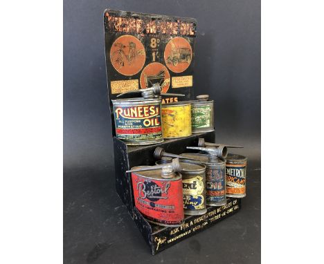 A rare 'Three-in-one' oil pictorial tin trade stand with images depicting a bicycle, a car and a pram, above two rows of asso