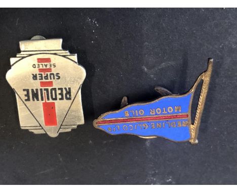 Two Redline lapel badges.
