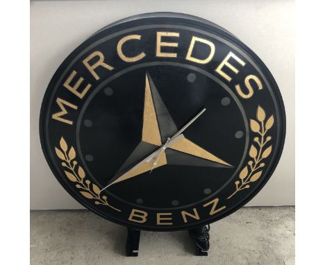 A Mercedes-Benz double sided circular dealership clock on metal bracket, 27 1/2" diameter.