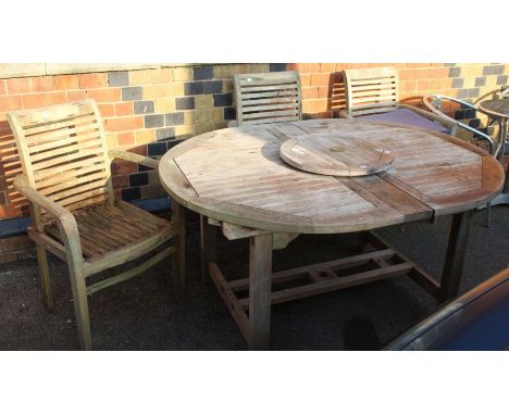 A teak garden table and three chairs.