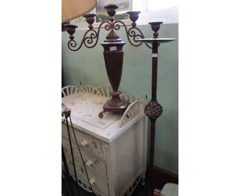 A five stem metal cast candelabra of urn form together with copper coloured floor standing candle stand