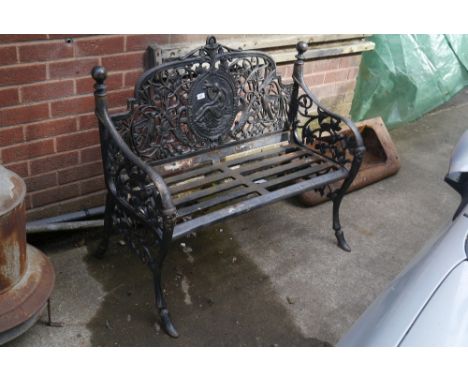 A contemporary cast garden bench, pierced back decorated with flora and fauna