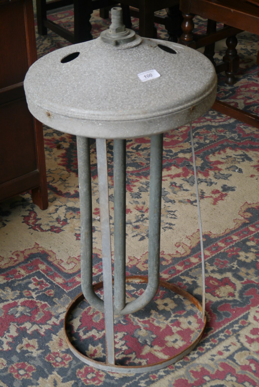 A vintage milk churn cooler