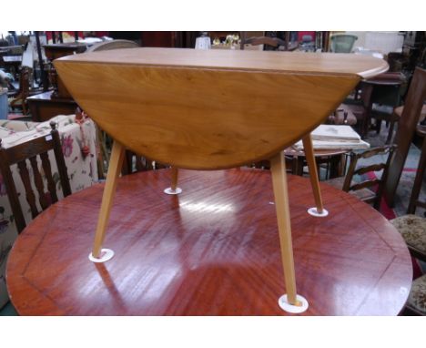 An Ercol elm drop leaf dining table