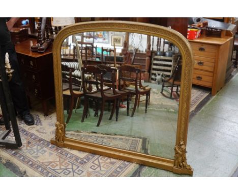 An early 20th century arch top mantel mirror, gilt frame with cherubs to each side