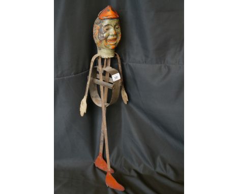 An interesting and unusual German tin plate automaton clown, with painted features, 65cm high, late 19th century