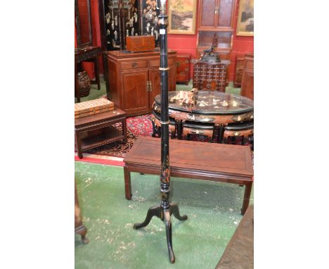 A Chinoiserie ebonised standard lamp, turned column, tripod base with cabriole legs, decorated with stylized flora throughout