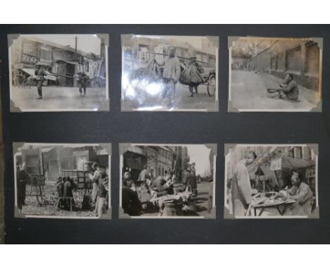 An interesting early 20th century photograph album, containing black and white photographs of a Chinese Army, images of capit