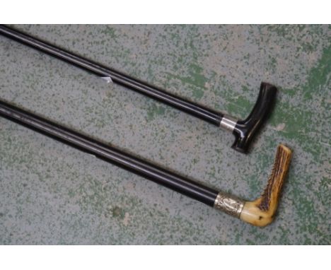 A Victorian ebonised walking stick, silver collar, marks rubbed, c.1880; another, similar (2)