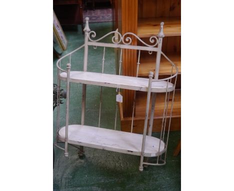 A wrought iron wall shelf with two eliptical marble shelves