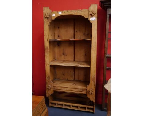 A pine wall unit, three open shelves over smaller spindle galleried shelf.