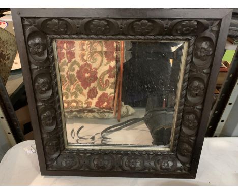 A SQUARE DARK WOODEN CARVED FRAMED BEVEL EDGED WALL MIRROR 