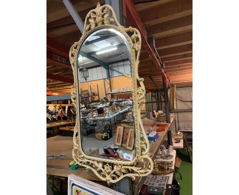 A ORNATE CREAM AND GILT FRAMED WALL MIRROR 