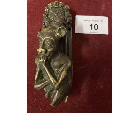 A SMALL BRASS DOOR KNOCKER IN THE FORM OF AN IMP 