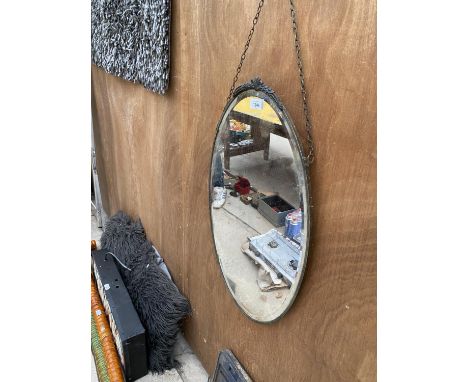 AN OVAL BEVELED EDGE ART DECO MIRROR 