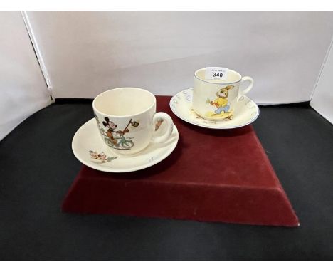 A BESWICK WALT DISNEY CUP AND SAUCER AND AN ELIJAH COTTON LTD LORD NELSON WARE CUP AND SAUCER 