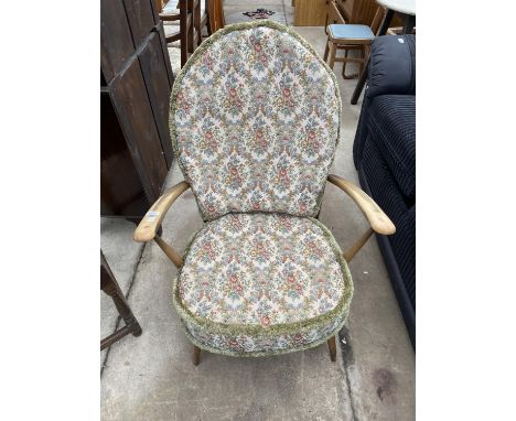 AN ERCOL ELM AND BEECH FIRESIDE CHAIR WITH FLEUR-DE-LYS BACK 