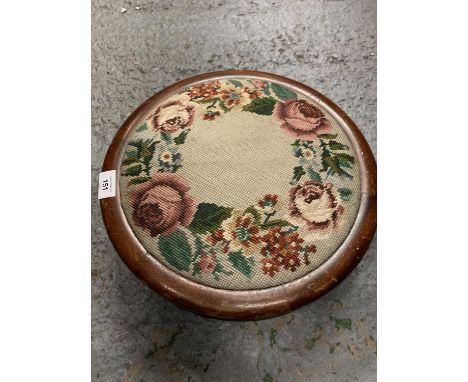A WOODEN CIRCULAR TAPESTRY TOPPED FOOTSTOOL 