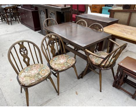 AN ERCOL DRAW LEAF ELM DINING TABLE WITH TWO ERCOL CARVERS AND FOUR DINING CHAIRS WITH PRINCE OF WALES FEATHER DESIGN 