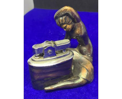 A 1960'S TABLE LIGHTER IN THE GUISE OF A LADY 