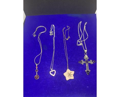 FOUR ASSORTED SILVER NECKLACES MARKED 925 AND STERLING WITH CROSS, FLOWER, HEART AND DROP PENDANTS 