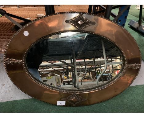 AN ARTS &amp; CRAFTS STYLE ORNATE COPPER FRAMED OVAL LANDSCAPE MIRROR 