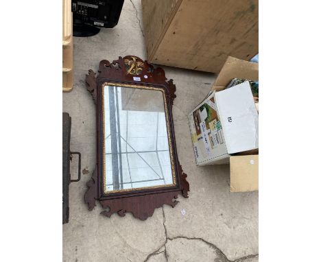 AN ORNATE AND CRAVED WOODEN FRAMED MIRROR 