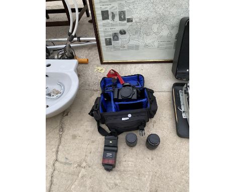 A CANON CAMERA IN A CAMERA BAG WITH TWO EXTRA LENSES AND A FLASH KIT 