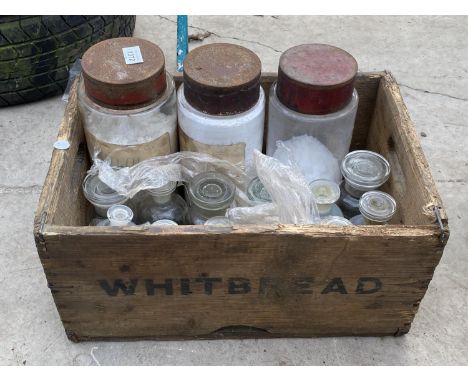 A VINTAGE WOODEN BOX CONTAINING GLASS STORAGE JARS AND SCIENTIFIC BOTTLES 